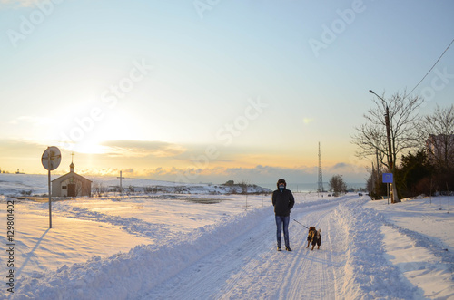 Man have a walk with dog winter