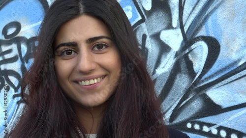 Beautiful young multiracial female in city smile happy face portrait.