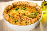 Homemade vegetable  quiche on wooden background