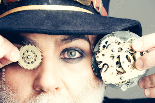 Foto Man keeps cogwheel and gears