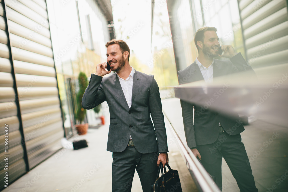 Stylish businessman walking outdoors Stylish businessman walking outdoors