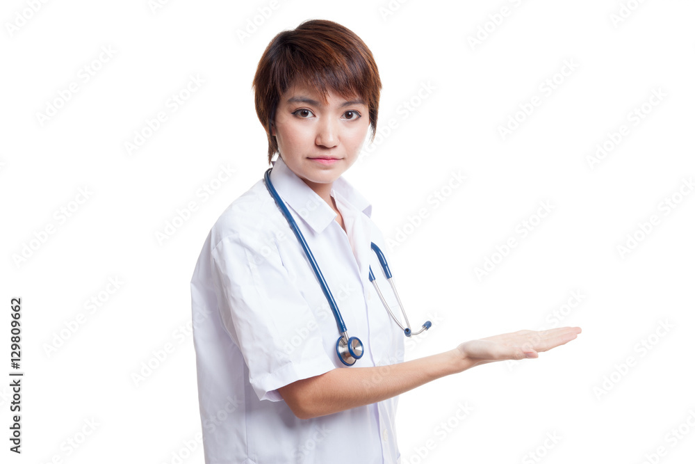 Asian young female doctor present something on her left. Asian young female doctor present something on her left.