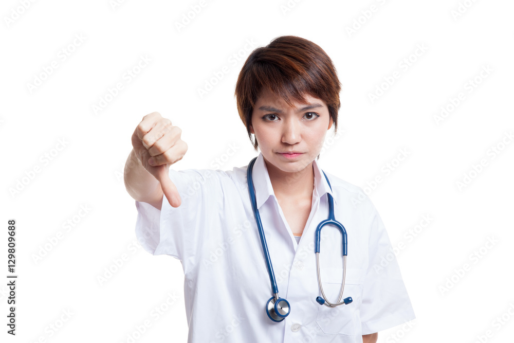 Young Asian female doctor angry show thumbs down. Young Asian female doctor angry show thumbs down.