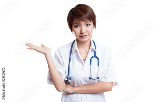 Asian young female doctor show something on her hand.