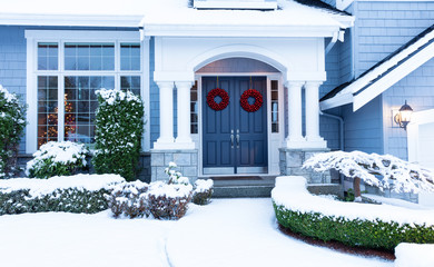 Walkway to home decorated for the winter Christmas or New Year holiday with snow
