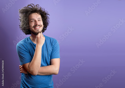 Billede på lærred Beautiful man in front of a colored background