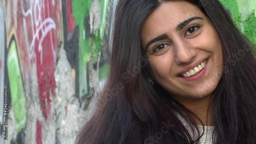 Beautiful young multiracial female in city smile happy face portrait.