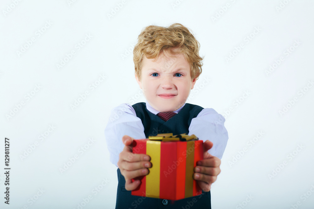 Funny boy in Santa red hat with a lot of gift boxes. Funny boy in Santa red hat with a lot of gift boxes.