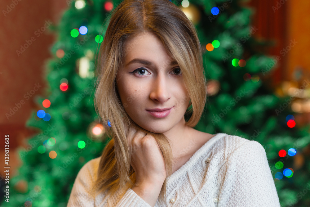 Beautiful woman portrait.,christmas tree lights background. happ