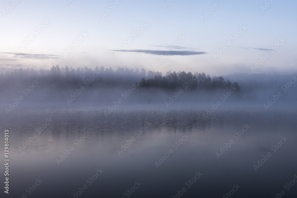 fog on the lake during sunrise in early morning in finland
