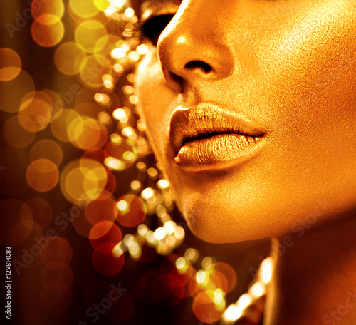 Beauty model girl with golden skin. Fashion art portrait
