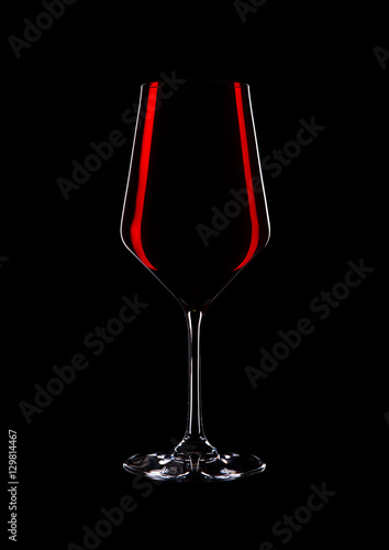Glass of red wine with reflection on black