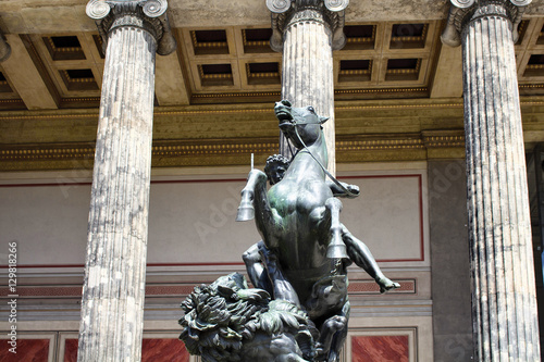 Amazon woman statue in front of cloumns of a museum in Berlin mitte. photo