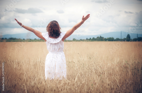 Happy woman on wheat field