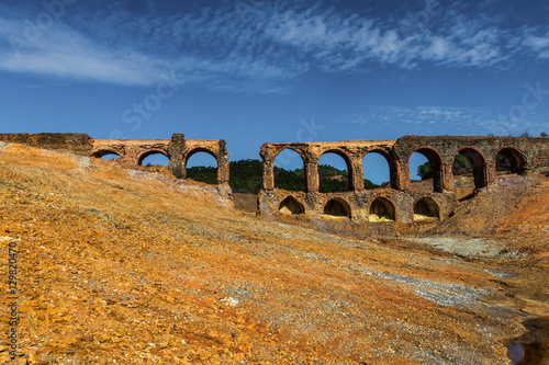 Old bridge in antique exploitation of copper mine in village Sotiel Coronada in  Huelva, Andalusia, Spain photo