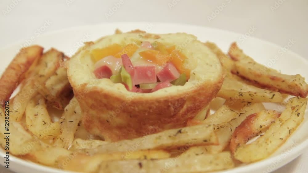 Homemade breakfast in potato basket with sausage, cucumber, bell pepper, cheese and potato sticks. Homemade breakfast in potato basket with sausage, cucumber, bell pepper, cheese and potato sticks.