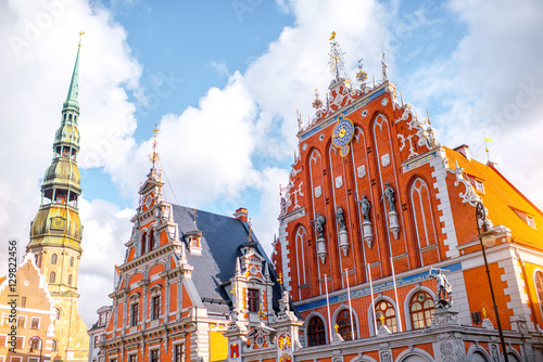 View on the central square with famous houses of Blackheads and cathedral tower in Riga city, Latvia