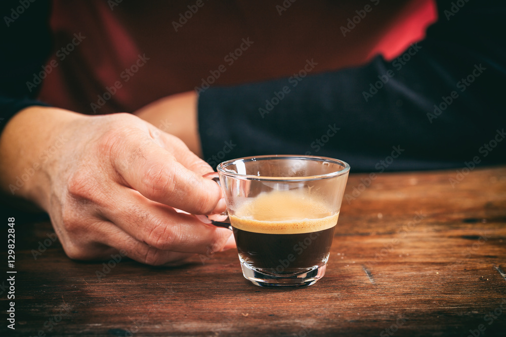 Waiter holding a cup of espresso Waiter holding a cup of espresso