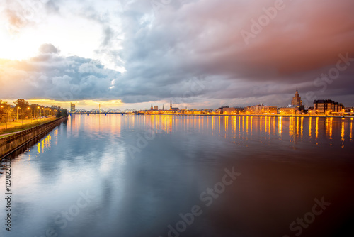 Night view on the illuminated bridge with reflection on the water in Riga  Latvia. Wide angle view with copy space