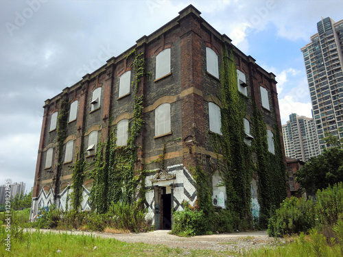 Abandoned brick building with spray paint graffiti 