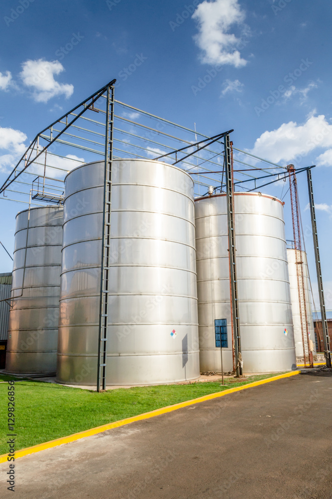 Vertical photo in color of many containers on a factory of alcoholic beverages Vertical photo in color of many containers on a factory of alcoholic beverages