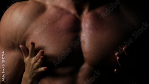 A Woman with her hands on a Sexy Muscular Chest of a Man close up