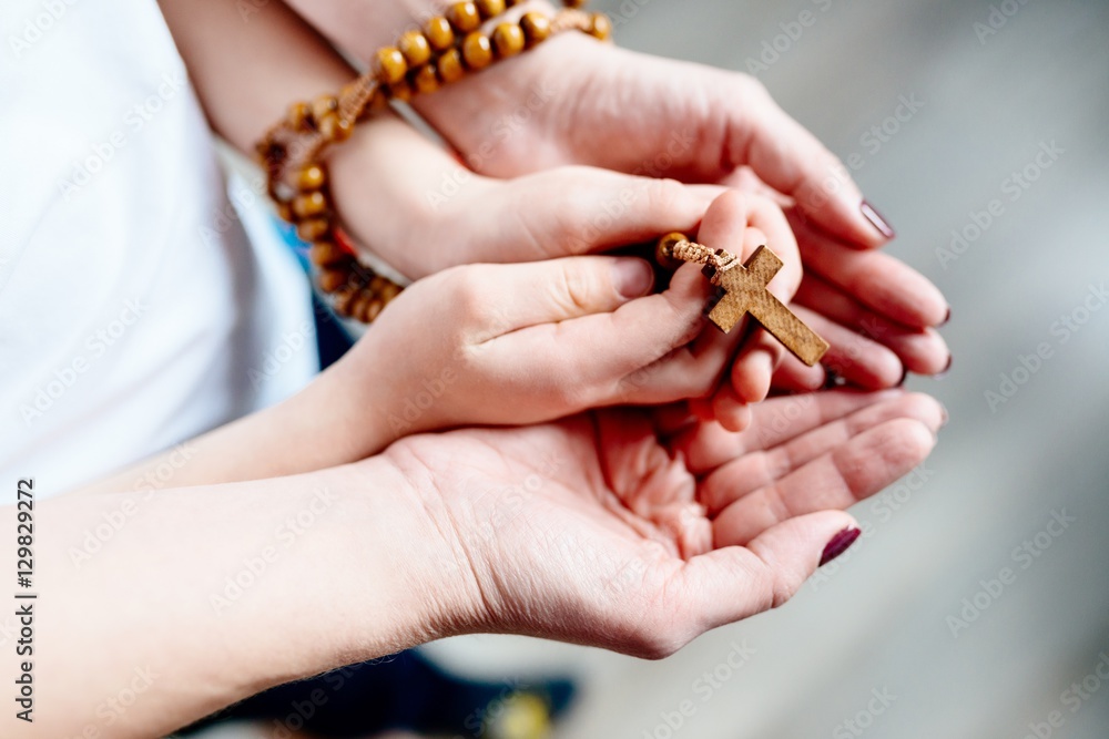 Family prayer with wooden rosary