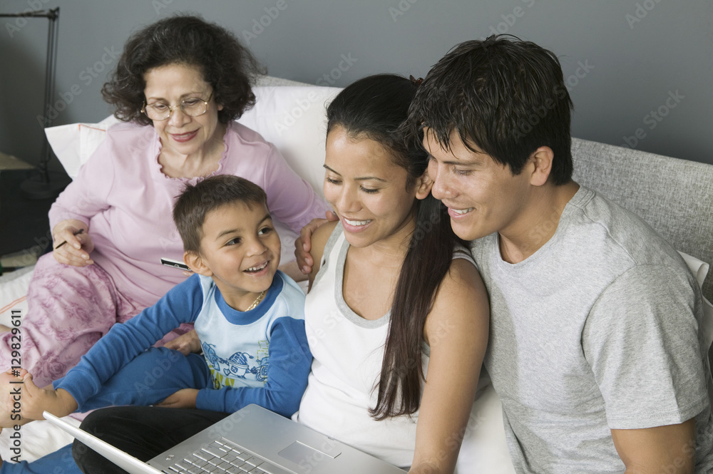 Family Using Laptop on Couch Family Using Laptop on Couch