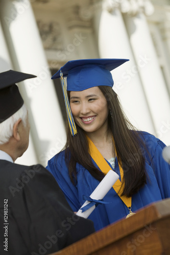 Graduate Receiving Diploma outside university photo