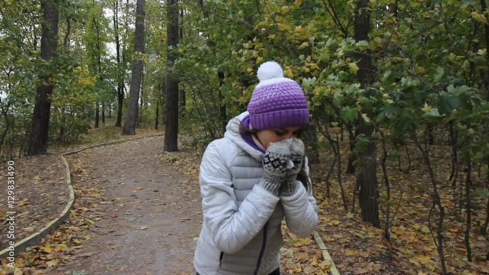Sick girl is coughing in the autumn park Sick girl is coughing in the autumn park