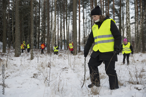 Sweden, Uppland, Upplands Vasby, Volunteers of Missing people organization in winter forest