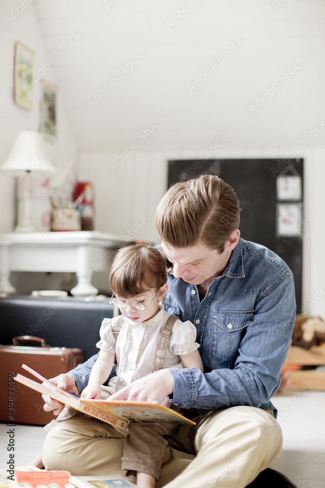 Sweden, Father reading with daughter (2-3) picture book Sweden, Father reading with daughter (2-3) picture book