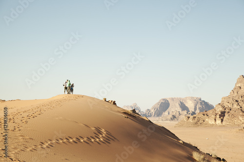 Jordan, Wadirum, People standing on sand dune photo