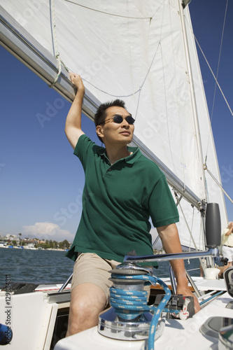 Man looking away while sailing boat