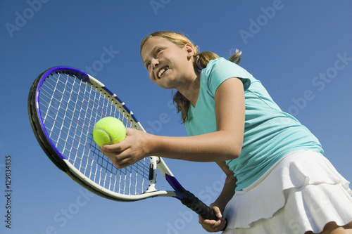Young girl on tennis court Preparing to Serve low angle view close up © moodboard