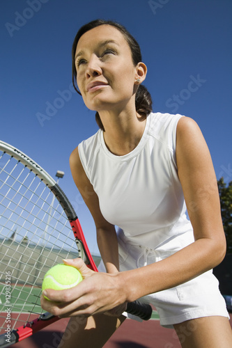 Female Tennis Player Preparing to Serve close up © moodboard