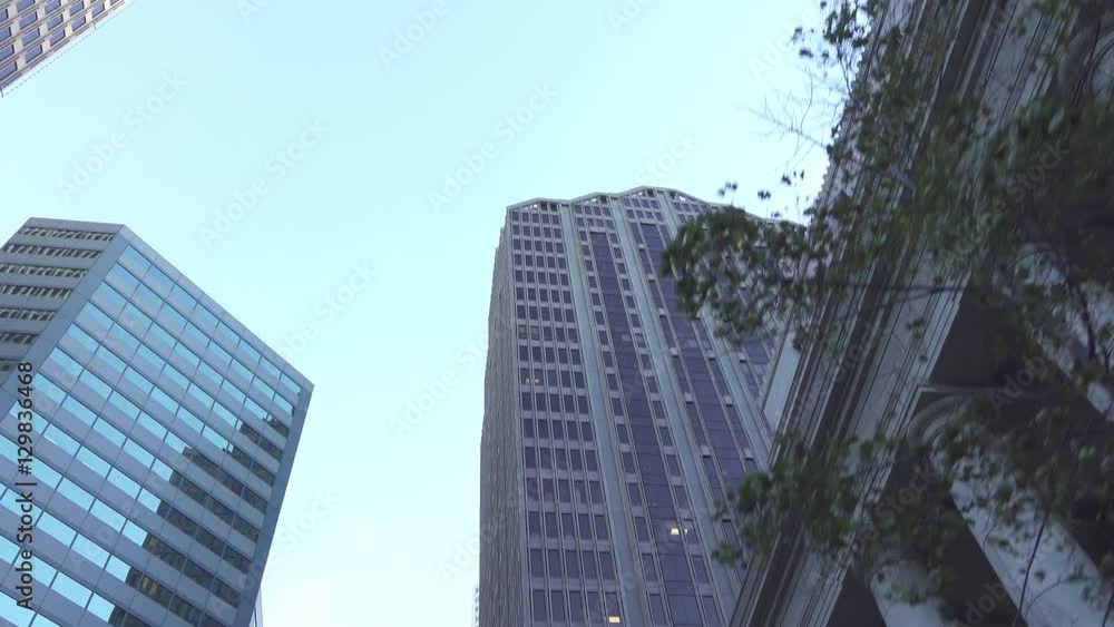 Driving through big city with glassy skyscrapers and office buildings Driving through big city with glassy skyscrapers and office buildings