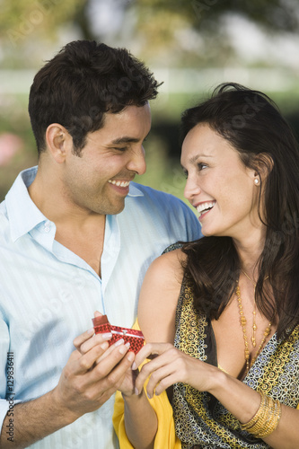 Happy Hispanic Latin man proposing woman