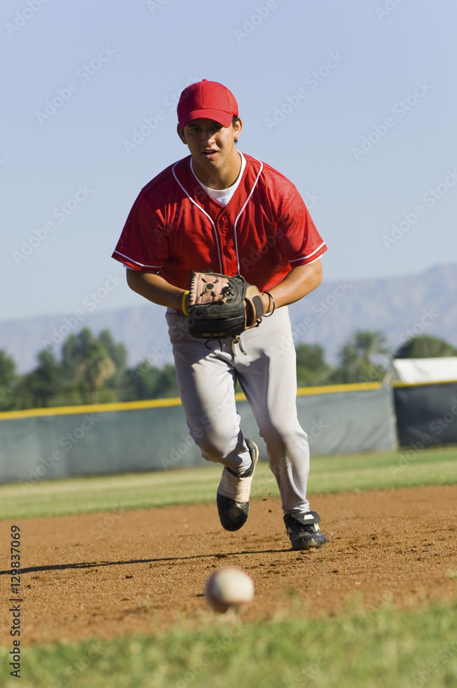 Full length of a baseball player running towards ball