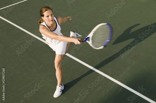 High angle view of sporty female playing on tennis court