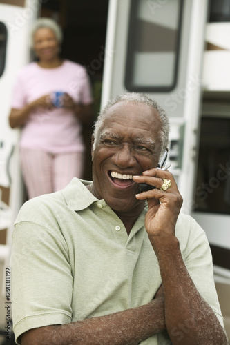 Senior man using mobile phone outdoors