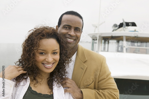 Portrait of a loving African American couple on the yacht during vacation