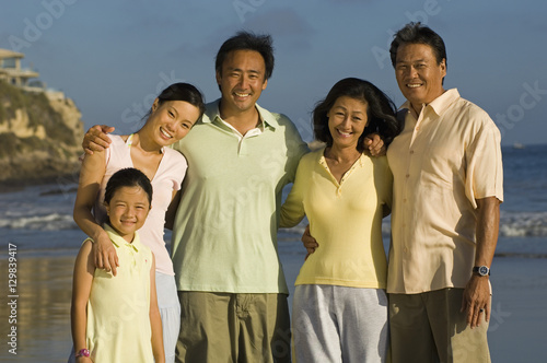 Portrait of happy family with girl posing on beach © moodboard