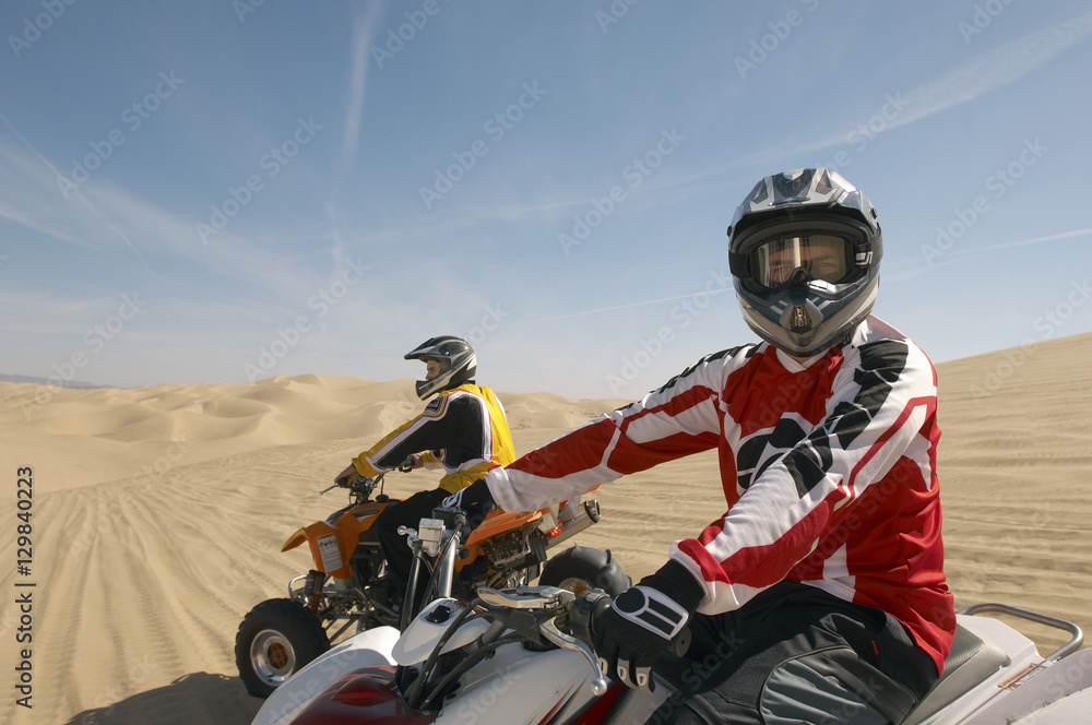 Two quad bike racers sitting on their bike Two quad bike racers sitting on their bike