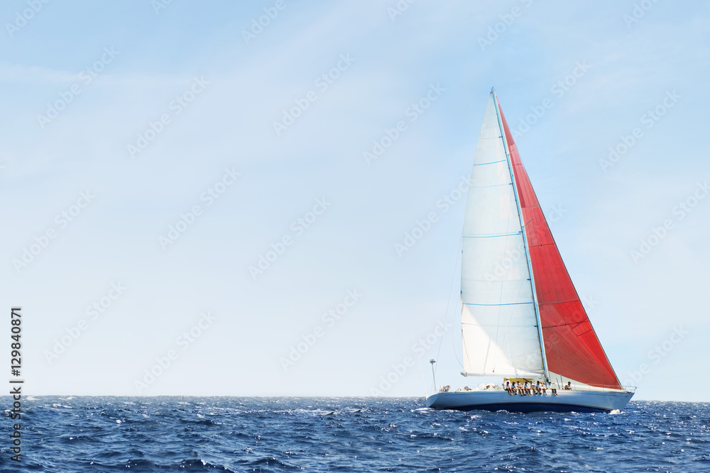 Side view of a sailboat in the peaceful blue ocean against sky