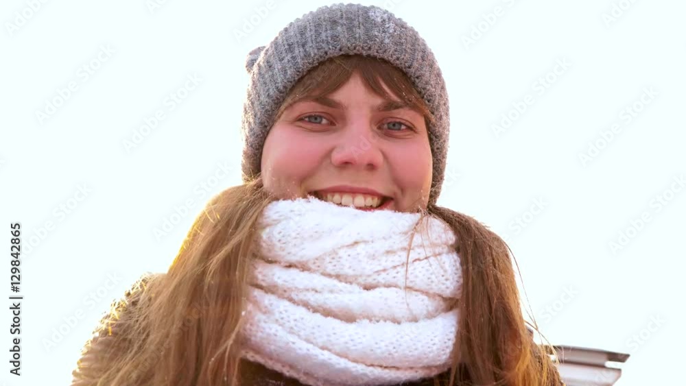 charming winter lady blowing a handful of snow right in the camera charming winter lady blowing a handful of snow right in the camera