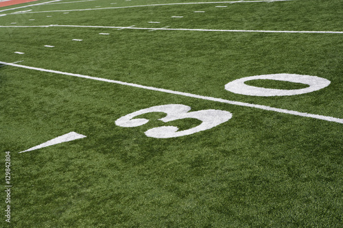 30 yard line on American football field with artificial turf