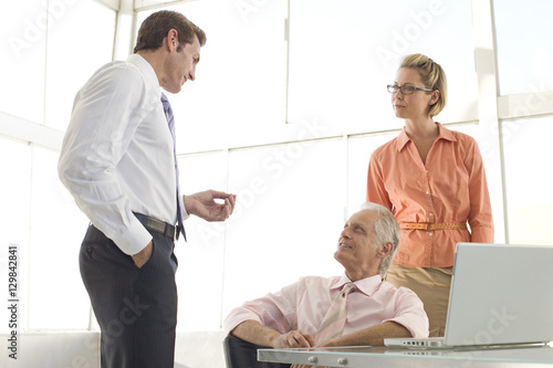 Male executive having discussion with colleagues in meeting room