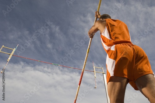Low angle view of a male pole vaulter preparing for a jump