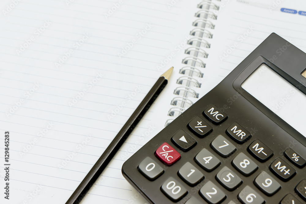 calculator and pen on blank notebook. calculator and pen on blank notebook.